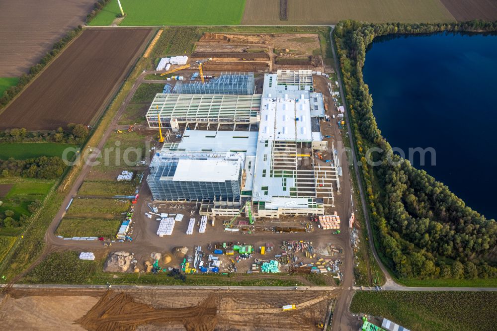 Aerial photograph Weeze - New construction site for the construction of buildings and production halls on the factory premises for the production of heavy corrugated cardboard on the street Am Sandthof in the district of Goch in Weeze in the federal state of North Rhine-Westphalia, Germany