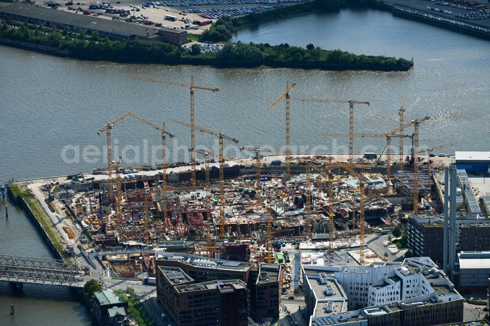 Hamburg from the bird's eye view: Construction site for the new building complex of the shopping center at Ueberseequartier at Chicagokai - Osakaallee in the area of the former Grasbrooks in the Hafencity district in Hamburg, Germany