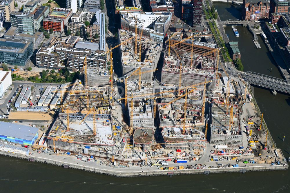 Hamburg from the bird's eye view: Construction site for the new building complex of the shopping center at Ueberseequartier at Chicagokai - Osakaallee in the area of the former Grasbrooks in the Hafencity district in Hamburg, Germany