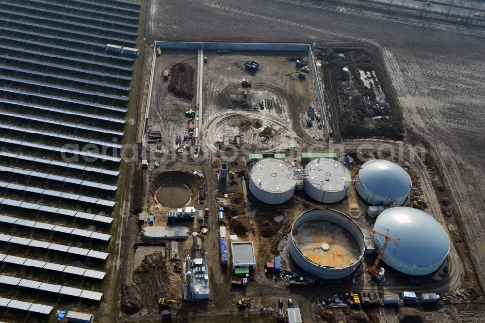 Oberkrämer from the bird's eye view: Construction of a biogas - plant on solar park in Oberkrämer in Brandenburg. The solar energy and photovoltaic location for renewable energy provides 36% of EEG power