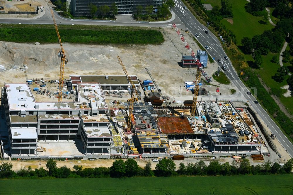 Unterschleißheim from the bird's eye view: Construction site to build a new office and commercial building Emmy-Noether-Ring - Landshuter Strasse in the district Lohhof in Unterschleissheim in the state Bavaria, Germany