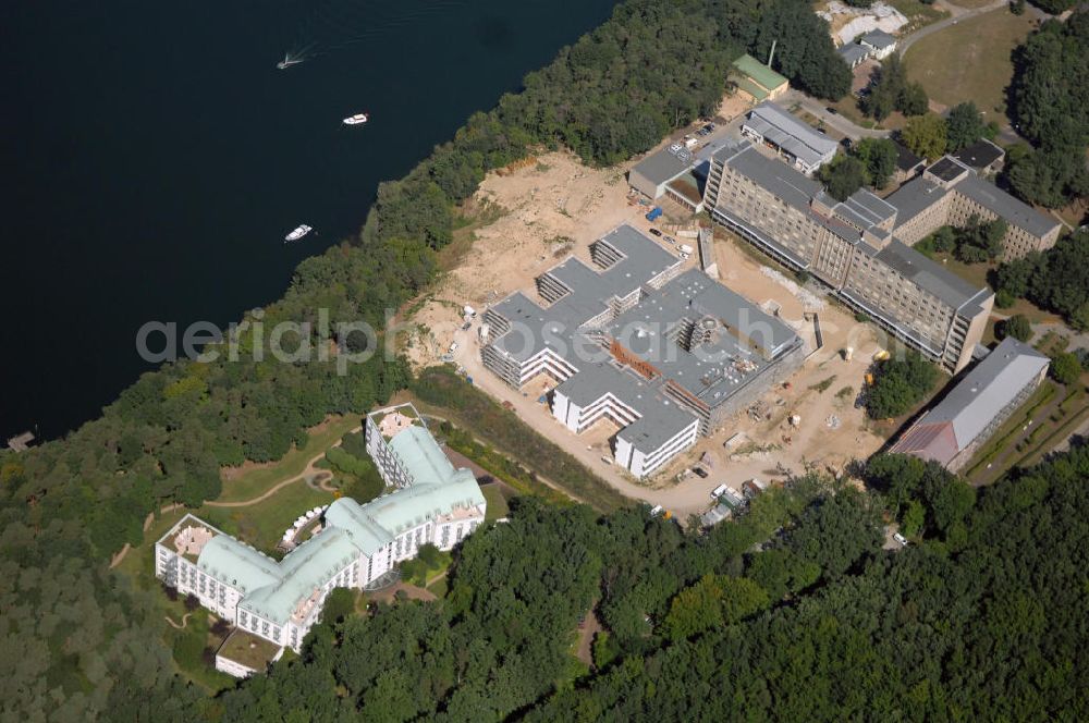 Rüdersdorf from the bird's eye view: Blick über die Klinik am See, Rehabilitationszentrum für Innere Medizin, auf die Baustelle des Krankenhaus Neubaus des Evangelisch-Freikirchlichen Krankenhaus Rüdersdorf. Im Hintergrund das alte Bettenhaus mit sämtlichen Nebengebäuden aus den 60er-Jahren, welches nach dem Umzug in das neue Gebäude abgerissen wird. Auf dem Gelände wird dann der Park des Krankenhauses entstehen, u. a. mit einem Kinderspielplatz und Medizinalkräutergarten. Das neue drei- und viergeschossige Krankenhaus hat eine Kapazität für 287 Betten in 135 Patientenzimmern. Kontakt: Krankenhaus und Poliklinik Rüdersdorf GmbH, Seebad 82/83, 15562 Rüdersdorf, Tel. +49(0)33638 83 0, Fax +49(0)33638 83 228, E-Mail: info @krankenhaus-ruedersdorf.de; Kontakt: Immanuel Diakonie GmbH (Holding), Am Kleinen Wannsee 5, 14109 Berlin, Tel. +490)30 80505 272, Fax +490)30 80505 266, E-Mail: mail@immanuel.de