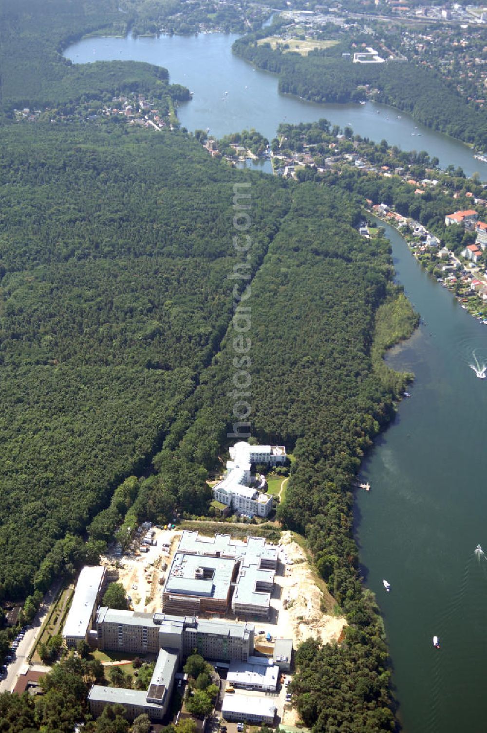 Rüdersdorf from the bird's eye view: Blick auf die Baustelle des Krankenhaus Neubaus des Evangelisch-Freikirchlichen Krankenhaus Rüdersdorf. Das Krankenhausgelände liegt direkt neben dem Areal der Klinik am See, Rehabilitationszentrum für Innere Medizin, hier im hinter der Baustelle. Im Vordergrund das alte Bettenhaus mit sämtlichen Nebengebäuden aus den 60er-Jahren, welches nach dem Umzug in das neue Gebäude abgerissen wird. Auf dem Gelände wird dann der Park des Krankenhauses entstehen, u. a. mit einem Kinderspielplatz und Medizinalkräutergarten. Das neue drei- und viergeschossige Krankenhaus hat eine Kapazität für 287 Betten in 135 Patientenzimmern. Kontakt: Krankenhaus und Poliklinik Rüdersdorf GmbH, Seebad 82/83, 15562 Rüdersdorf, Tel. +49(0)33638 83 0, Fax +49(0)33638 83 228, E-Mail: info @krankenhaus-ruedersdorf.de; Kontakt: Immanuel Diakonie GmbH (Holding), Am Kleinen Wannsee 5, 14109 Berlin, Tel. +490)30 80505 272, Fax +490)30 80505 266, E-Mail: mail@immanuel.de