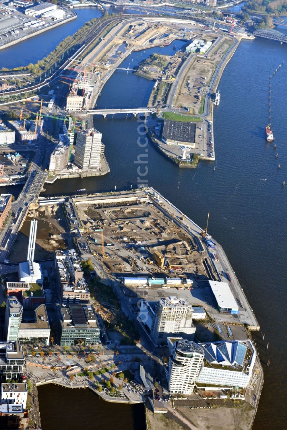 Hamburg from above - Construction site for the new building complex of the shopping center at Ueberseequartier at Chicagokai - Osakaallee in the area of the former Grasbrooks in the Hafencity district in Hamburg, Germany