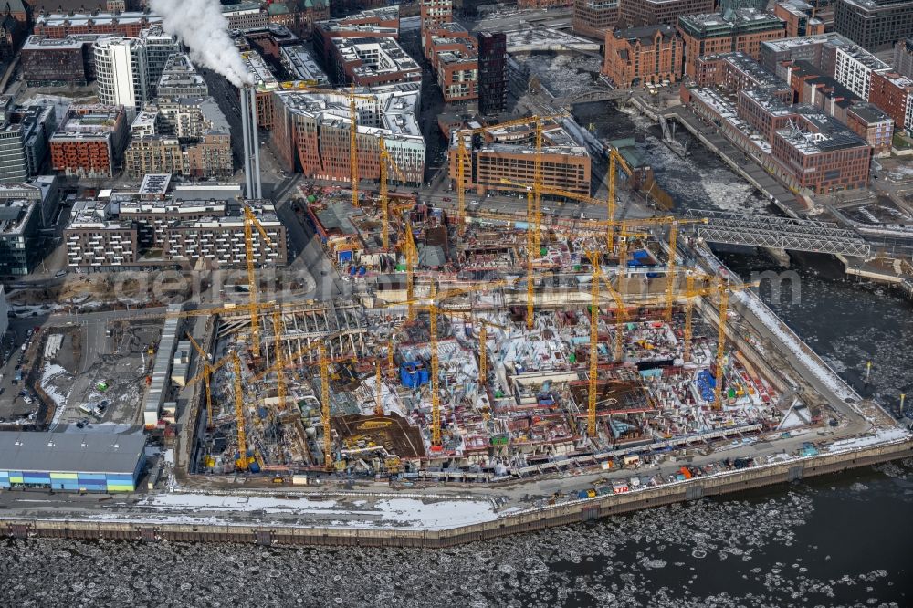 Hamburg from the bird's eye view: Construction site for the new building complex of the shopping center at Ueberseequartier at Chicagokai - Osakaallee in the area of the former Grasbrooks in the Hafencity district in Hamburg, Germany