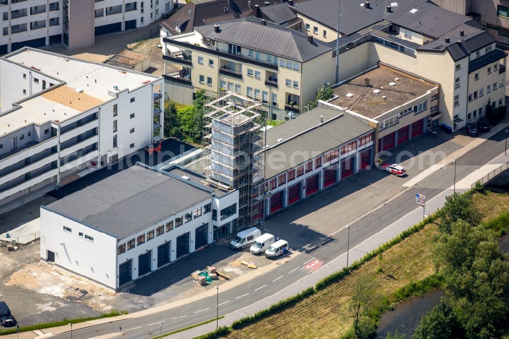 Aerial image Meschede - Building of the retirement home Rinschen Park of the company Siedlungs- und Baugenossenschaft Meschede eG aswell as the building complex of the volunteer fire brigade of Meschede beneath the roads Fritz-Honsel-Strasse and Muehlenweg and the river Ruhr in Meschede in the state North Rhine-Westphalia