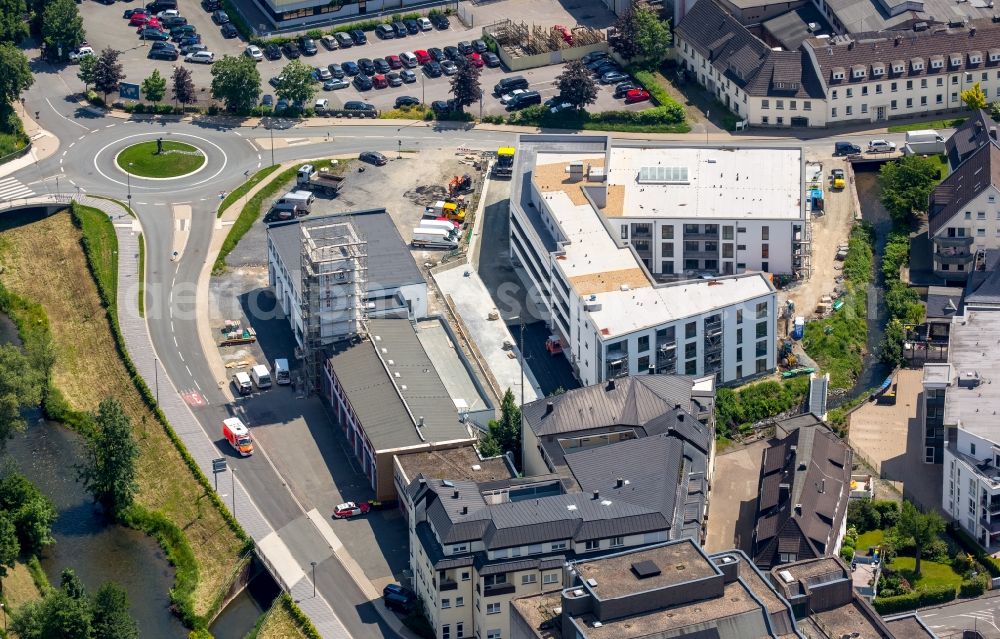 Aerial image Meschede - Building of the retirement home Rinschen Park of the company Siedlungs- und Baugenossenschaft Meschede eG aswell as the building complex of the volunteer fire brigade of Meschede beneath the roads Fritz-Honsel-Strasse and Muehlenweg and the river Ruhr in Meschede in the state North Rhine-Westphalia