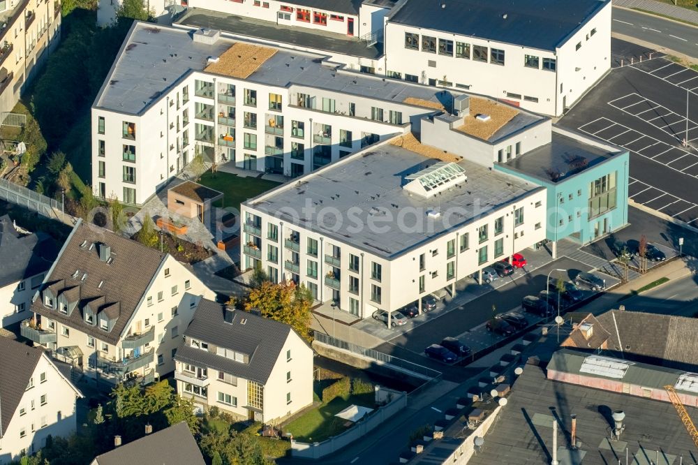 Aerial image Meschede - Building of the retirement home Rinschen Park of the company Siedlungs- und Baugenossenschaft Meschede eG aswell as the building complex of the volunteer fire brigade of Meschede beneath the roads Fritz-Honsel-Strasse and Muehlenweg and the river Ruhr in Meschede in the state North Rhine-Westphalia