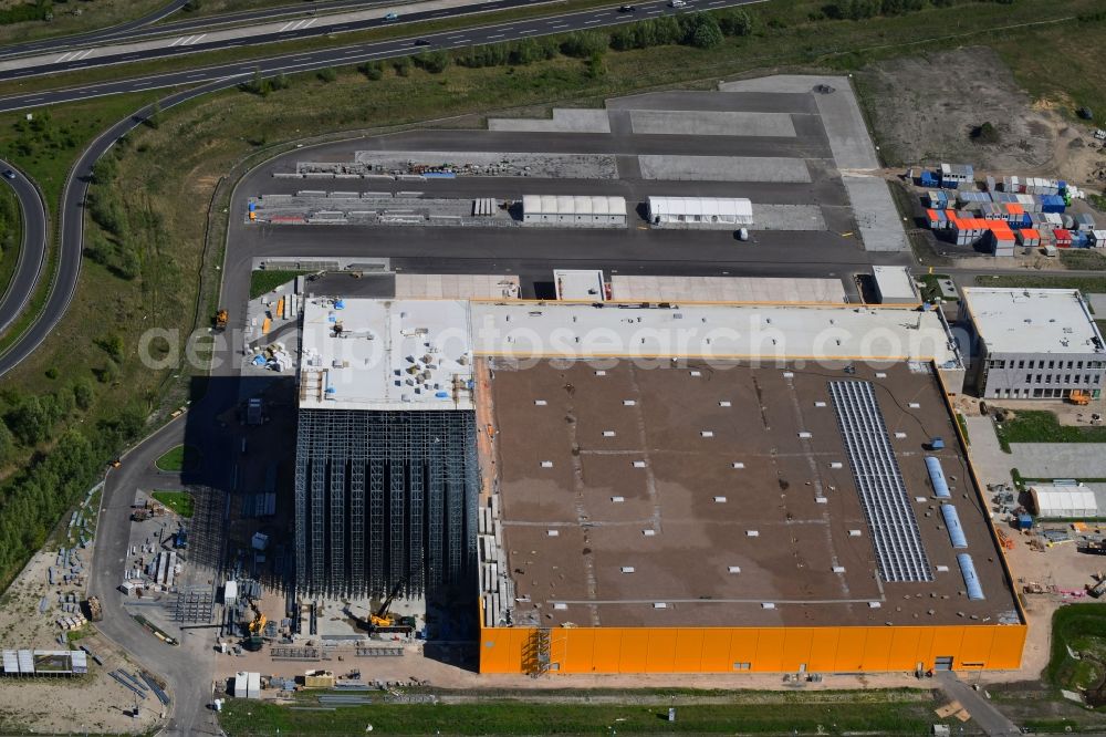 Wustermark from the bird's eye view: Construction site and assembly work for the construction of a high-bay warehouse building complex and logistics center on the premises dm VZ Verteilerzentrum in Wustermark in the state Brandenburg, Germany