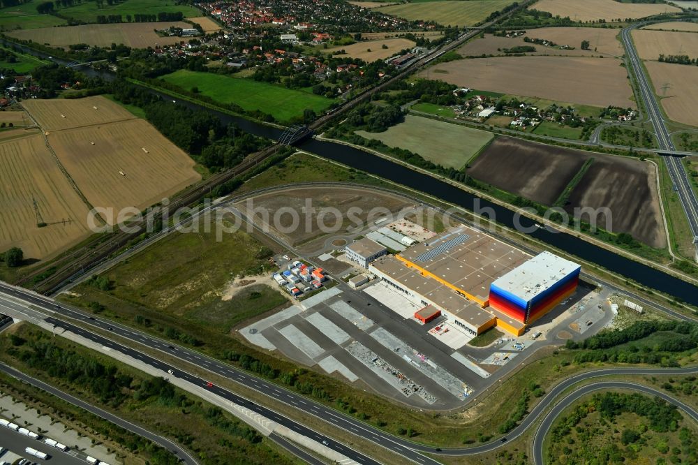 Wustermark from the bird's eye view: Construction site and assembly work for the construction of a high-bay warehouse building complex and logistics center on the premises dm VZ Verteilerzentrum in Wustermark in the state Brandenburg, Germany