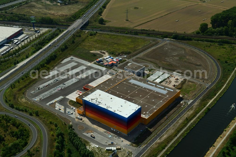 Wustermark from the bird's eye view: Construction site and assembly work for the construction of a high-bay warehouse building complex and logistics center on the premises dm VZ Verteilerzentrum in Wustermark in the state Brandenburg, Germany