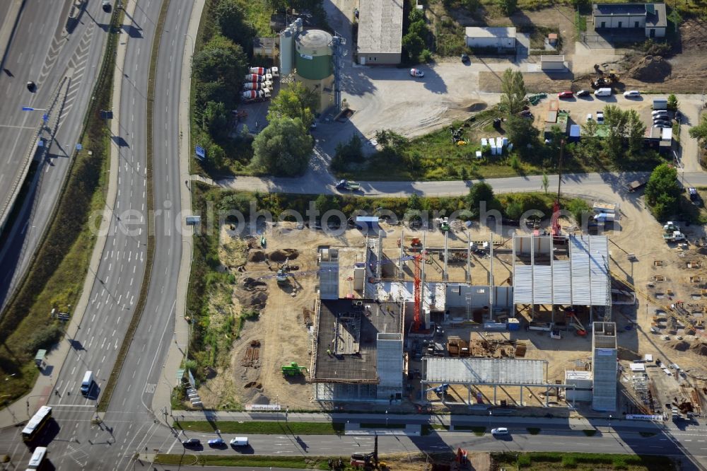 Schönefeld from the bird's eye view: Look at the construction site of a new building of an industrial hall at the Hans-Grade-Allee in Schönefeld in Brandenburg. Construction company is the company Hundhausen