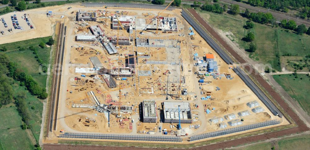 Aerial photograph Großbeeren - Baustelle vom Neubau der Justizvollzugsanstalt JVA Heidering Großbeeren im Landkreis Teltow-Fläming in Brandenburg durch die Senatsverwaltung für Justiz. Der Neubau der Haftanstalt in Großbeeren wird nur elektrisch und mit einem Erdwall gesichert statt mit einer koventionellen Gefängnismauer. Die Projektentwurf erfolgte durch das Architekturbüro Hohensinn. Ausführende Baufirmen sind die Bleck & Söhne Hoch- und Tiefbau GmbH & Co. KG, sowie die Schälerbau Berlin. Construction site of the new penal institution Heidering Grossbeeren.