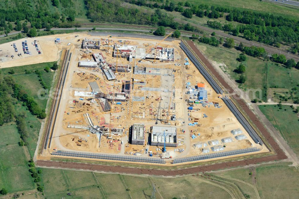 Großbeeren from above - Baustelle vom Neubau der Justizvollzugsanstalt JVA Heidering Großbeeren im Landkreis Teltow-Fläming in Brandenburg durch die Senatsverwaltung für Justiz. Der Neubau der Haftanstalt in Großbeeren wird nur elektrisch und mit einem Erdwall gesichert statt mit einer koventionellen Gefängnismauer. Die Projektentwurf erfolgte durch das Architekturbüro Hohensinn. Ausführende Baufirmen sind die Bleck & Söhne Hoch- und Tiefbau GmbH & Co. KG, sowie die Schälerbau Berlin. Construction site of the new penal institution Heidering Grossbeeren.