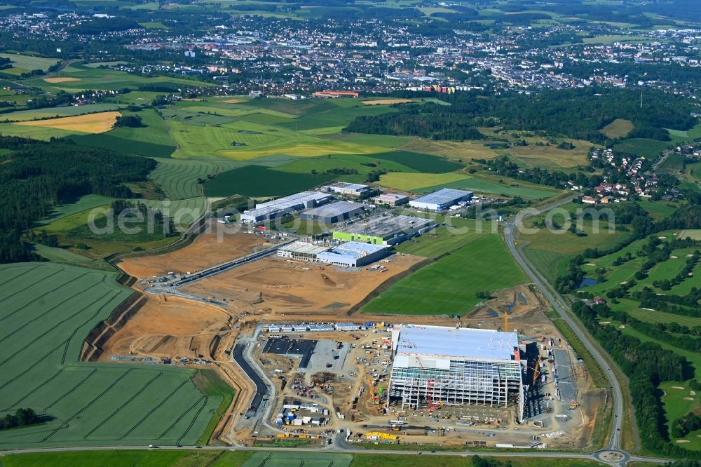 Hof from above - Construction site to build a new building complex on the site of the logistics center Amazon Warenlager in Gewerbepark Hochfranken in the district Gumpertsreuth in Hof in the state Bavaria, Germany