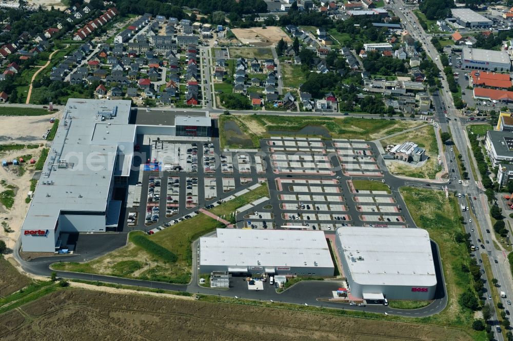 Berlin from the bird's eye view: Construction site for the new building home-center of the Porta-Group at Pilgramer street in the district Mahlsdorf in Berlin