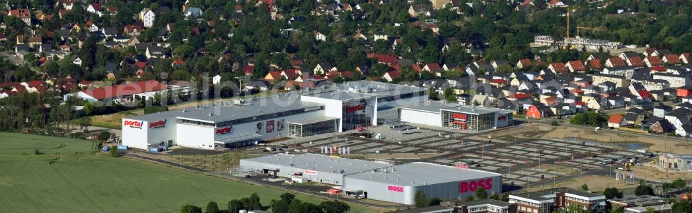 Berlin from the bird's eye view: Construction site for the new building home-center of the Porta-Group at Pilgramer street in the district Mahlsdorf in Berlin