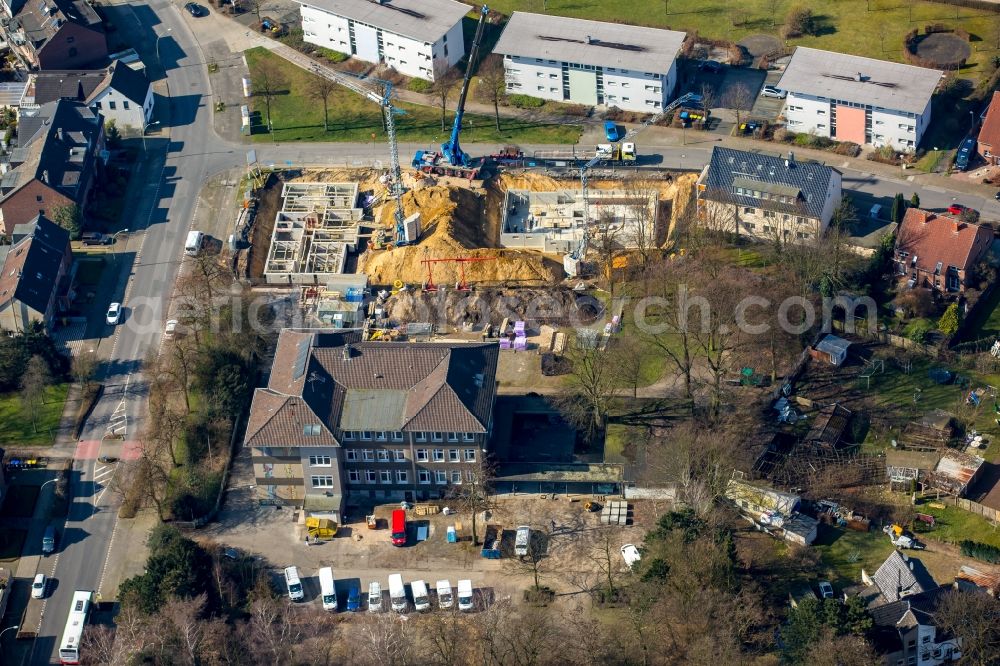 Bottrop from the bird's eye view: Construction site to build a new multi-family residential complex at the Tannenstrasse and Trappenstrasse, which will initially be used as a refugee accommodation in Bottrop in the state North Rhine-Westphalia