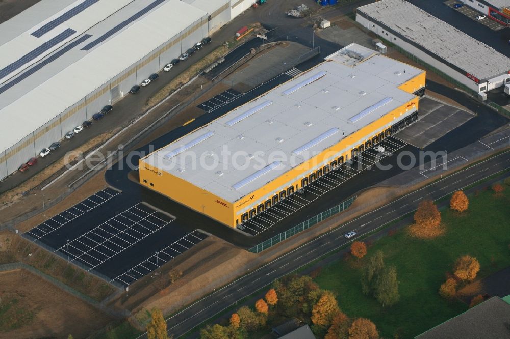 Efringen-Kirchen from above - Construction of the new package deliver center of Deutsche Post DHL in the industrial area Schloettle in Efringen-Kirchen in the state of Baden-Wuerttemberg. The growing internet trade requires the appropriate infrastructure and expansion