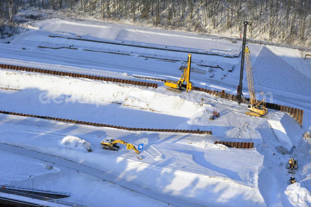 Aerial photograph Niederfinow - Blick auf die winterlich verschneite Baustelle des Neubaus des Schiffshebewerkes Niederfinow Nord durch die DSD Brückenbau GmbH, die Johann Bunte Bauunternehmung GmbH & Co. KG , Bilfinger Berger Ingenieurbau GmbH und die Siemag GmbH. Look at the new building of the boat lift Niederfinow North Bridge. The new building needed because the old boat lift of 1934 has now reached the end of its life. To maintain the function of the Havel-Oder waterway, it must therefore be replaced by a new building on schedule.