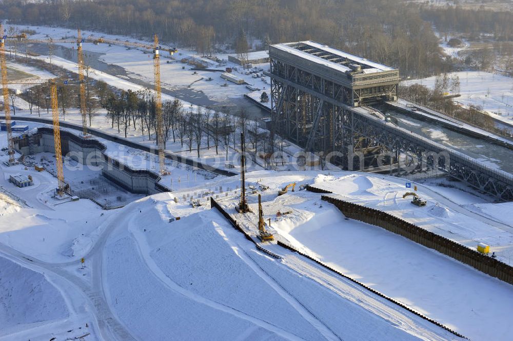 Aerial image Niederfinow - Blick auf die winterlich verschneite Baustelle des Neubaus des Schiffshebewerkes Niederfinow Nord durch die DSD Brückenbau GmbH, die Johann Bunte Bauunternehmung GmbH & Co. KG , Bilfinger Berger Ingenieurbau GmbH und die Siemag GmbH. Look at the new building of the boat lift Niederfinow North Bridge. The new building needed because the old boat lift of 1934 has now reached the end of its life. To maintain the function of the Havel-Oder waterway, it must therefore be replaced by a new building on schedule.