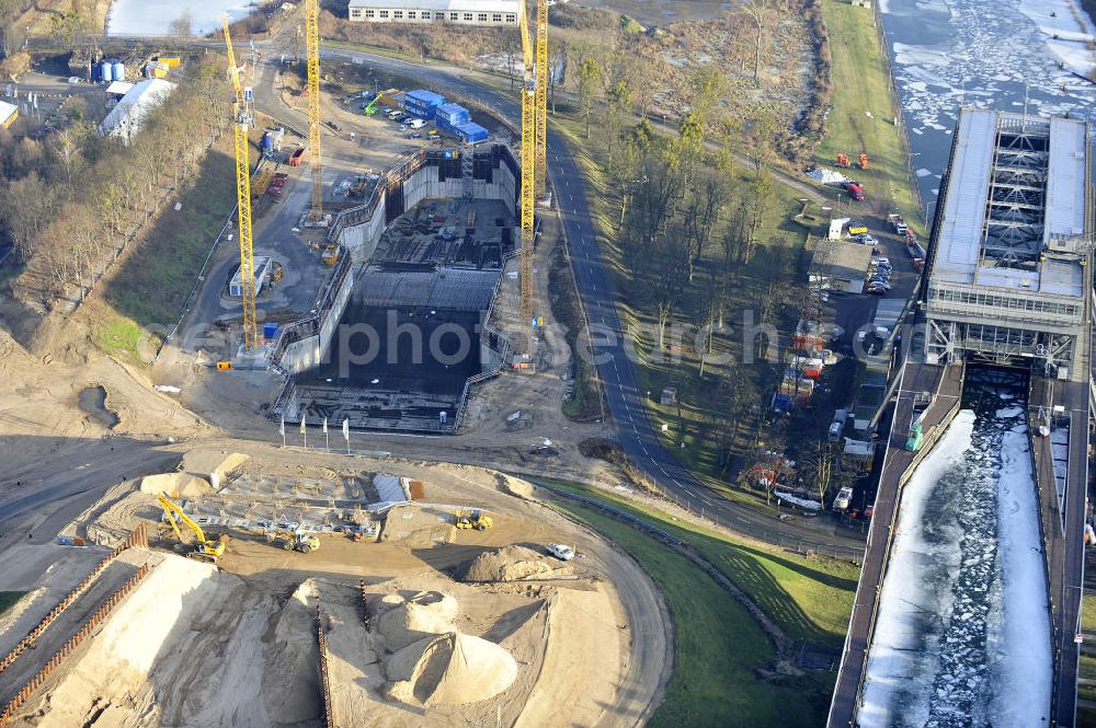 Aerial photograph Niederfinow - Blick auf die Baustelle des Neubaus des Schiffshebewerkes Niederfinow Nord durch die DSD Brückenbau GmbH, die Johann Bunte Bauunternehmung GmbH & Co. KG , Bilfinger Berger Ingenieurbau GmbH und die Siemag GmbH. Look at the new building of the boat lift Niederfinow North Bridge. The new building needed because the old boat lift of 1934 has now reached the end of its life. To maintain the function of the Havel-Oder waterway, it must therefore be replaced by a new building on schedule.