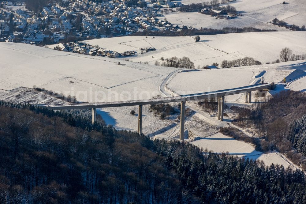 Bestwig from above - Wintry snowy viaduct Nuttlar under construction overlooking the municipality Bestwig in North Rhine-Westphalia