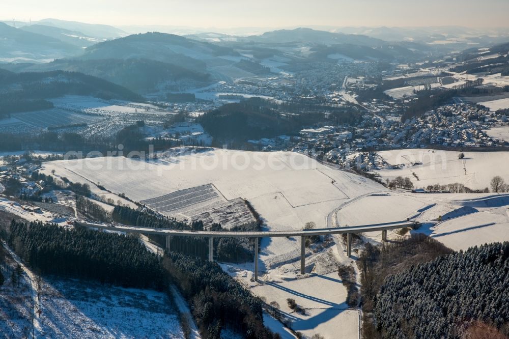 Aerial image Bestwig - Wintry snowy viaduct Nuttlar under construction overlooking the municipality Bestwig in North Rhine-Westphalia