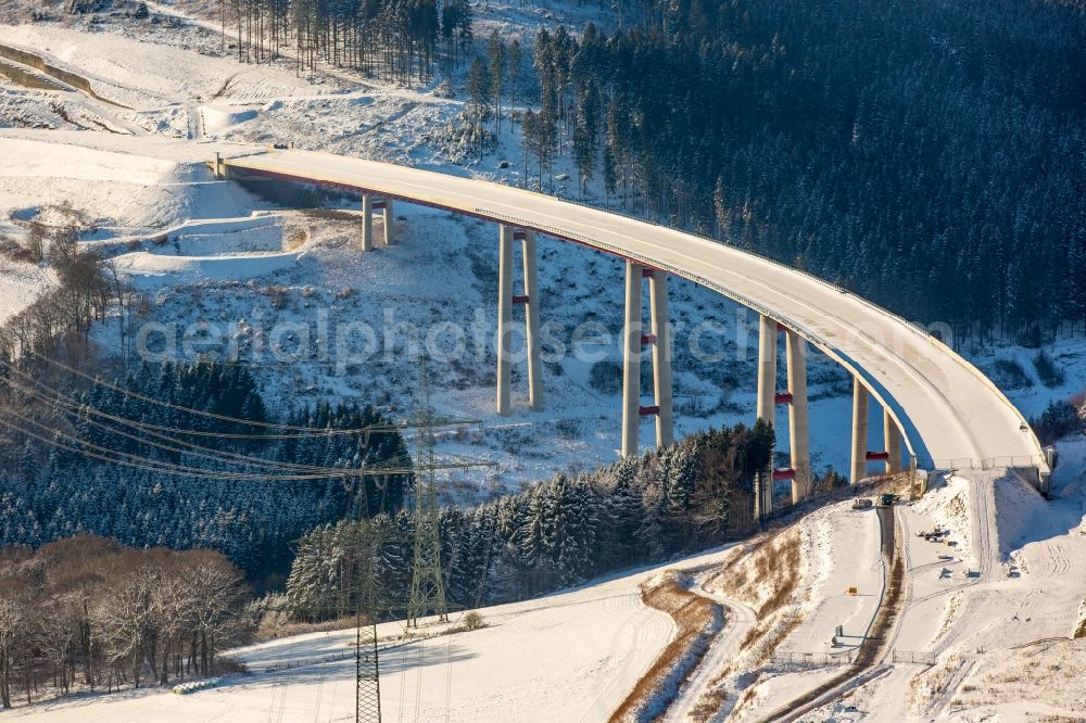 Aerial photograph Bestwig - Wintry snowy viaduct Nuttlar under construction overlooking the municipality Bestwig in North Rhine-Westphalia