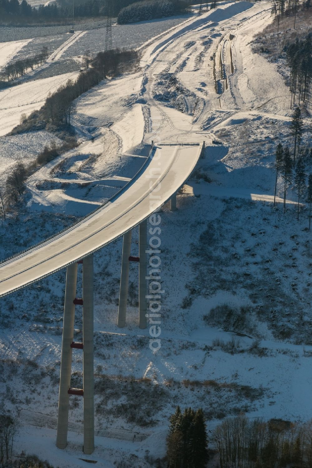 Aerial image Bestwig - Wintry snowy viaduct Nuttlar under construction overlooking the municipality Bestwig in North Rhine-Westphalia