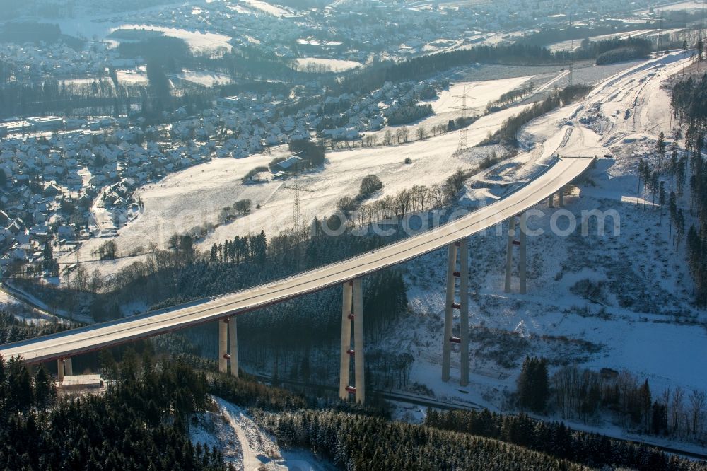 Aerial photograph Bestwig - Wintry snowy viaduct Nuttlar under construction overlooking the municipality Bestwig in North Rhine-Westphalia