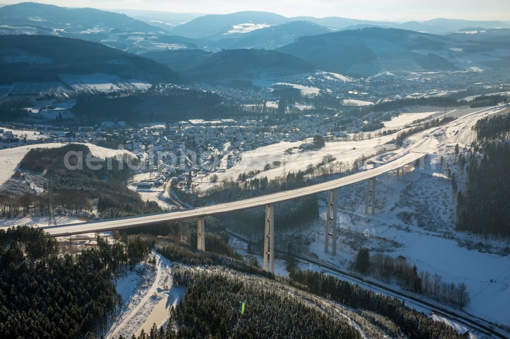 Bestwig from above - Wintry snowy viaduct Nuttlar under construction overlooking the municipality Bestwig in North Rhine-Westphalia