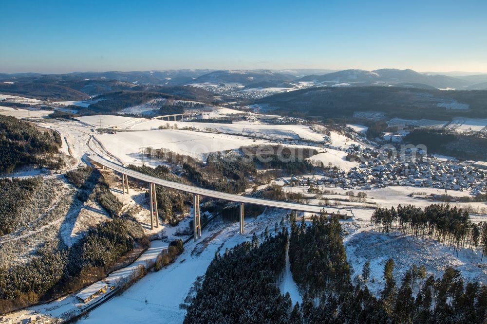 Aerial image Bestwig - Wintry snowy viaduct Nuttlar under construction overlooking the municipality Bestwig in North Rhine-Westphalia