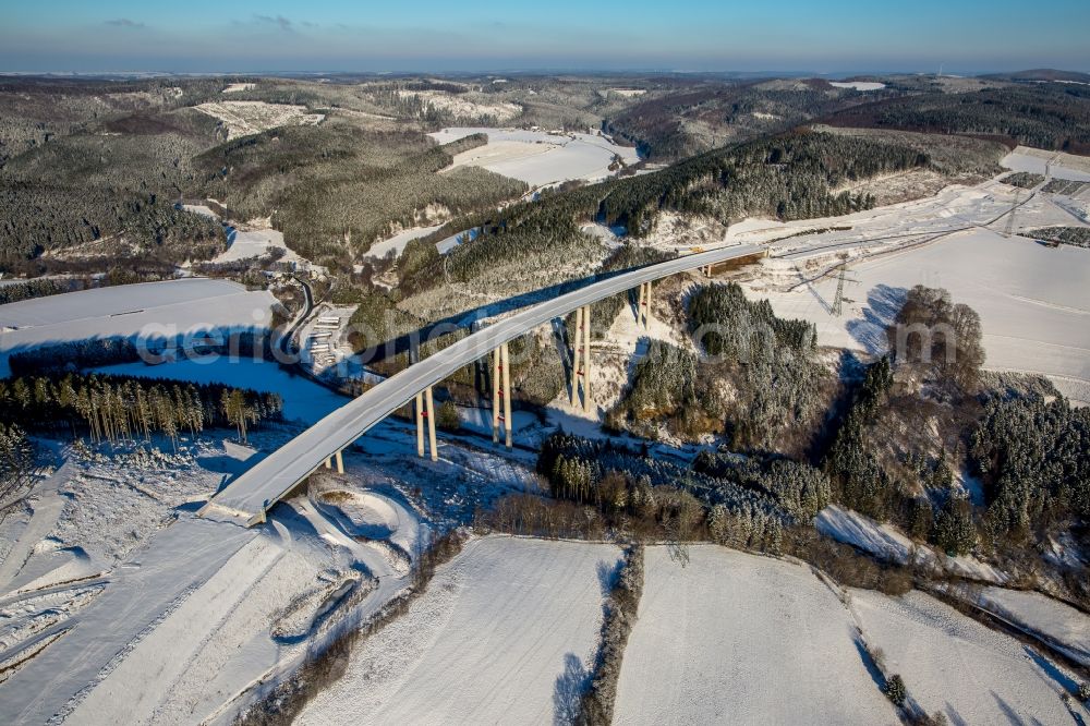 Aerial photograph Bestwig - Wintry snowy viaduct Nuttlar under construction overlooking the municipality Bestwig in North Rhine-Westphalia