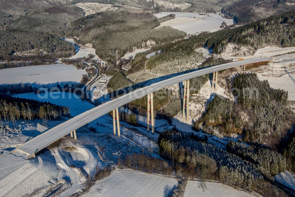 Bestwig from above - Wintry snowy viaduct Nuttlar under construction overlooking the municipality Bestwig in North Rhine-Westphalia