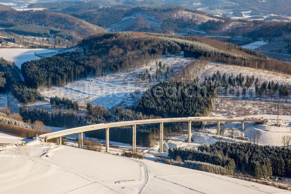 Aerial image Bestwig - Wintry snowy viaduct Nuttlar under construction overlooking the municipality Bestwig in North Rhine-Westphalia