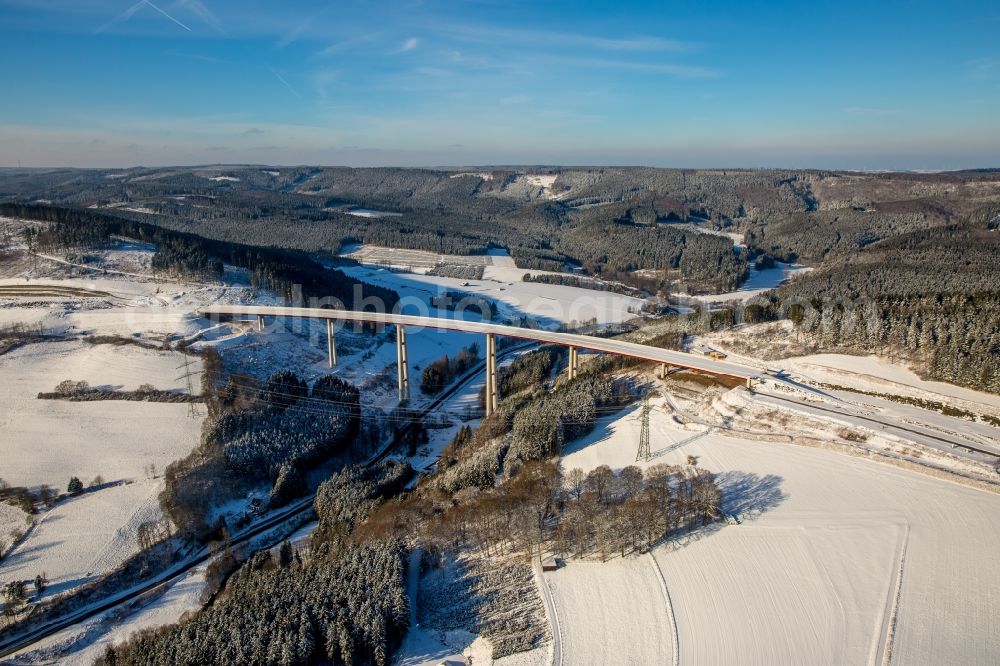 Aerial photograph Bestwig - Wintry snowy viaduct Nuttlar under construction overlooking the municipality Bestwig in North Rhine-Westphalia