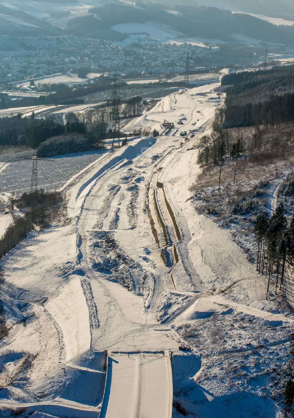 Bestwig from the bird's eye view: Wintry snowy viaduct Nuttlar under construction overlooking the municipality Bestwig in North Rhine-Westphalia