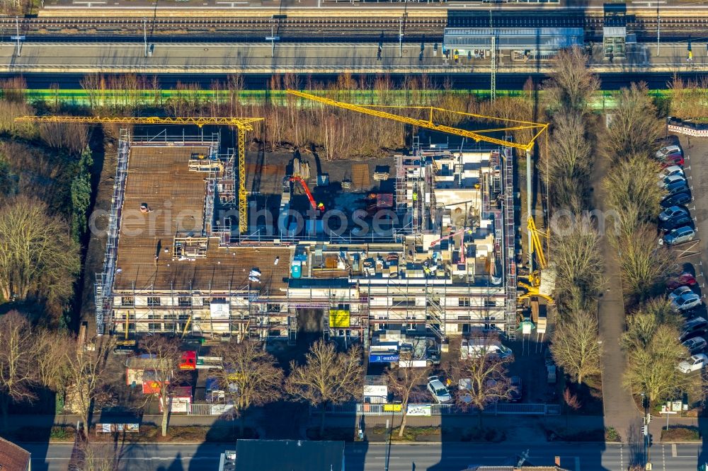 Holzwickede from the bird's eye view: New construction of a residential and commercial building on Bahnhofstrasse in Holzwickede in the state North Rhine-Westphalia, Germany