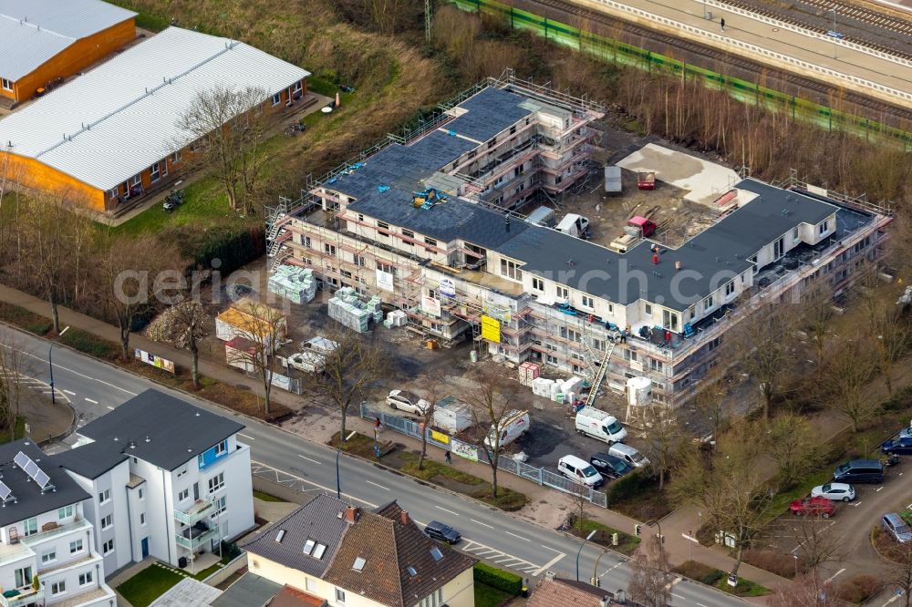 Holzwickede from the bird's eye view: New construction of a residential and commercial building on Bahnhofstrasse in Holzwickede in the state North Rhine-Westphalia, Germany