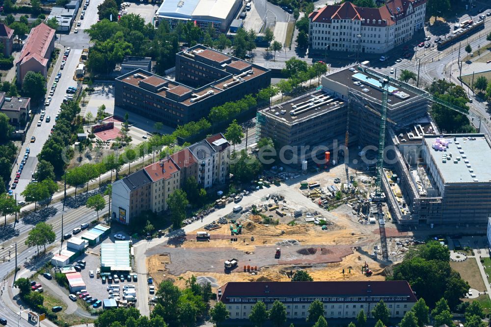 Leipzig from the bird's eye view: Construction site for the new construction of the residential and commercial building district Prague Triangle with a new construction of a high school on Prager Strasse - Philipp-Rosenthal-Strasse in the district Zentrum-Suedost in Leipzig in the state Saxony, Germany