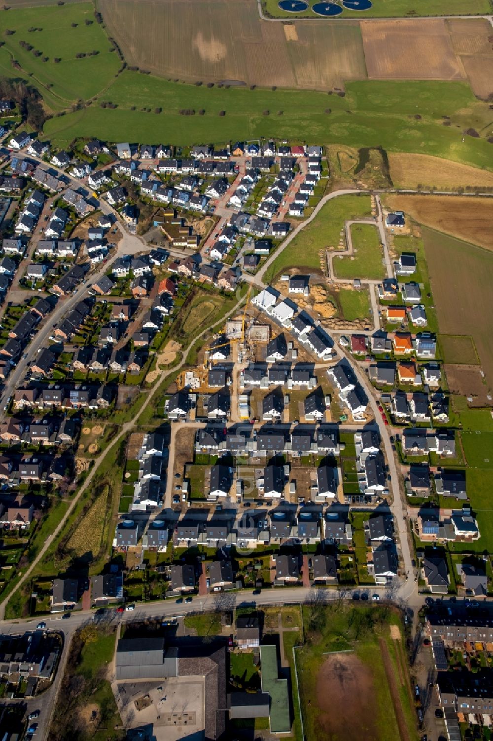 Moers from above - Construction sites for new construction residential area of detached housing estate along Planetenstrasse in Moers in the state of North Rhine-Westphalia