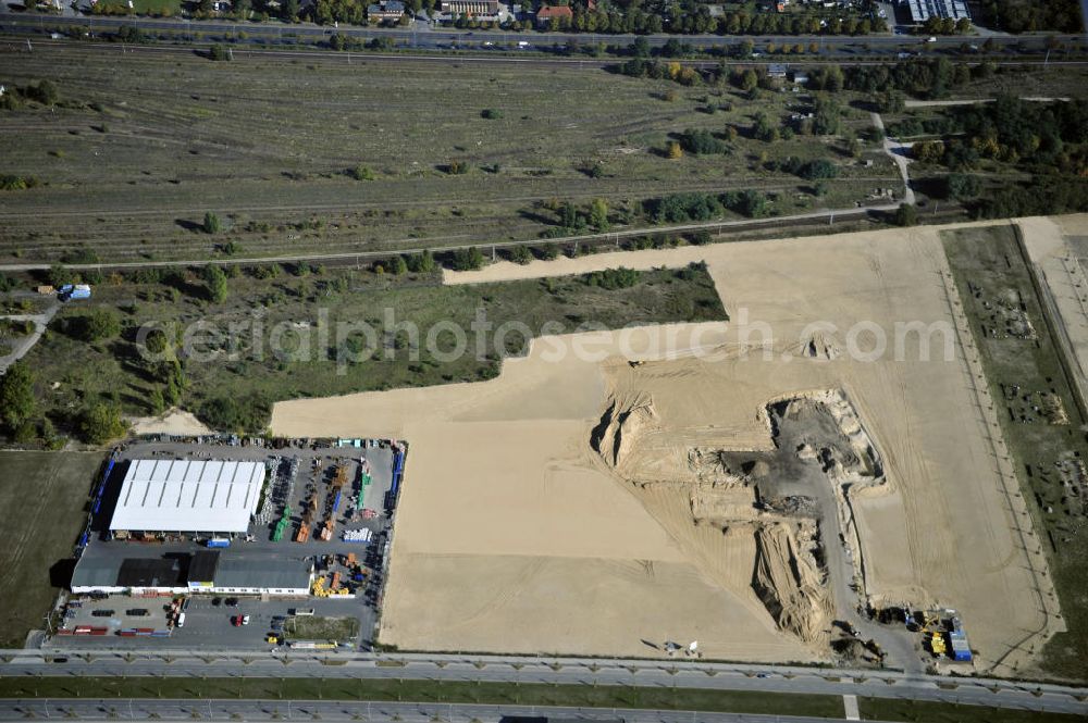 Aerial image Berlin - Blick auf eine Planfläche im Gewerbegebiet Flugplatz Johannisthal am Groß-Berliner Damm. Das Gelände dient heute als Baufläche für Einfamilienhäuser und als Gewerbegebiet. Des weiteren befindet sich heute auf dem Gelände unter an derem der Aerodynamische Park als Teil des Campus der Humboldt-Universität zu Berlin. Der Name des Platzes weist auf den besonderen Charakter und die historische wie architektonische Bedeutung durch die prägnanten und dominierenden Baudenkmale der ehemaligen Deutschen Versuchsanstalt für Luftfahrt e.V. hin. Das mittlerweile entstandene grüne Biotop auf der Fläche der ehemaligen Start- und Landebahn ist in eine Parklandschaft integriert worden, dem Europapark, der nach einem Wettbewerb seit den späten 1990er Jahren hier entsteht. View onto the construction site at the industrial area at the former airport Johannisthal. Today the area serves as ab building area and as an industrial area.