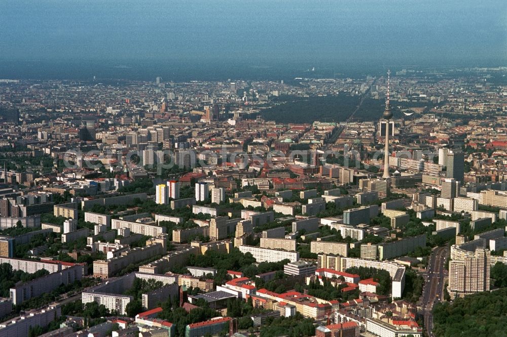 Aerial photograph Berlin - The morning light can shine brightly the facades of new buildings in the very center of the City-Ost in Berlin-Mitte. In the center of the building ensembles dominated the Berlin TV Tower, the landmark of the capital, the residential areas and the Alexanderplatz. As a white picture frame around a black image appears the striking high-rise of the International Trade Centre at Friedrichstrasse