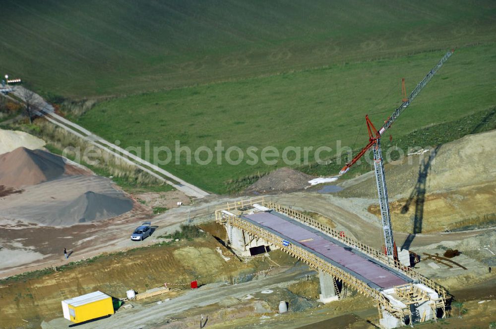 Aerial image NEUKIRCHEN - Baustellen an der Neubautrasse der BAB A 4 - Umfahrung Hörselberge in Thüringen bei Eisenach. Das Bieterkonsortium VINCI Concessions / Hochtief PPP (50/50) hat den Zuschlag für das A-Modell BAB A 4 Umfahrung Hörselberge (km 238,5 bis km 283,2) erhalten. Die bei diesem Projekt auf der Bauausführungsebene gegründete Arbeitsgemeinschaft wird von der EUROVIA Infra GmbH angeführt, des Weiteren sind hier die Unternehmen Hochtief, Strassing Limes und Rädlinger beteiligt. Durchgeführt werden die im Zuge dieses Projektes notwendigen Arbeiten unter an derem von den Mitarbeitern der Niederlassung Weimar der EUROVIA Verkehrsbau Union sowie der Niederlassungen Abbruch und Erdbau, Betonstraßenbau, Ingenieurbau und TECO Schallschutz der EUROVIA Beton. DEGES; STREIF Baulogistik.