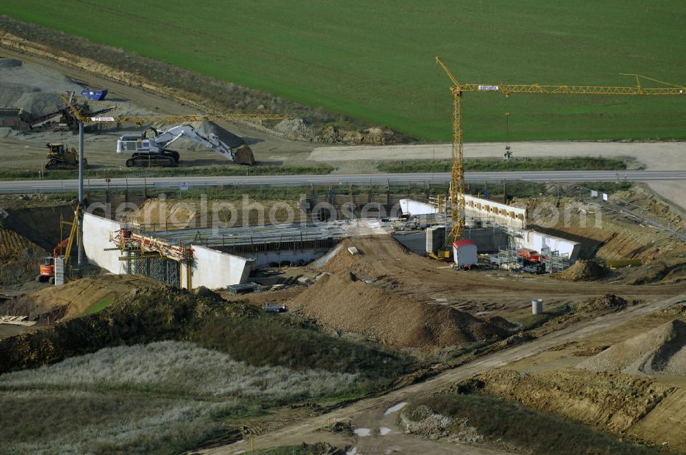 Aerial photograph NEUKIRCHEN - Baustellen an der Neubautrasse der BAB A 4 - Umfahrung Hörselberge in Thüringen bei Eisenach. Das Bieterkonsortium VINCI Concessions / Hochtief PPP (50/50) hat den Zuschlag für das A-Modell BAB A 4 Umfahrung Hörselberge (km 238,5 bis km 283,2) erhalten. Die bei diesem Projekt auf der Bauausführungsebene gegründete Arbeitsgemeinschaft wird von der EUROVIA Infra GmbH angeführt, des Weiteren sind hier die Unternehmen Hochtief, Strassing Limes und Rädlinger beteiligt. Durchgeführt werden die im Zuge dieses Projektes notwendigen Arbeiten unter an derem von den Mitarbeitern der Niederlassung Weimar der EUROVIA Verkehrsbau Union sowie der Niederlassungen Abbruch und Erdbau, Betonstraßenbau, Ingenieurbau und TECO Schallschutz der EUROVIA Beton. DEGES; STREIF Baulogistik.