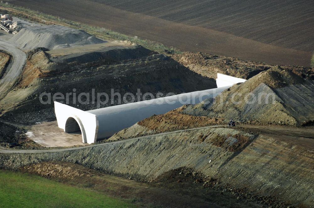 NEUKIRCHEN from the bird's eye view: Baustellen an der Neubautrasse der BAB A 4 - Umfahrung Hörselberge in Thüringen bei Eisenach. Das Bieterkonsortium VINCI Concessions / Hochtief PPP (50/50) hat den Zuschlag für das A-Modell BAB A 4 Umfahrung Hörselberge (km 238,5 bis km 283,2) erhalten. Die bei diesem Projekt auf der Bauausführungsebene gegründete Arbeitsgemeinschaft wird von der EUROVIA Infra GmbH angeführt, des Weiteren sind hier die Unternehmen Hochtief, Strassing Limes und Rädlinger beteiligt. Durchgeführt werden die im Zuge dieses Projektes notwendigen Arbeiten unter an derem von den Mitarbeitern der Niederlassung Weimar der EUROVIA Verkehrsbau Union sowie der Niederlassungen Abbruch und Erdbau, Betonstraßenbau, Ingenieurbau und TECO Schallschutz der EUROVIA Beton. DEGES; STREIF Baulogistik.