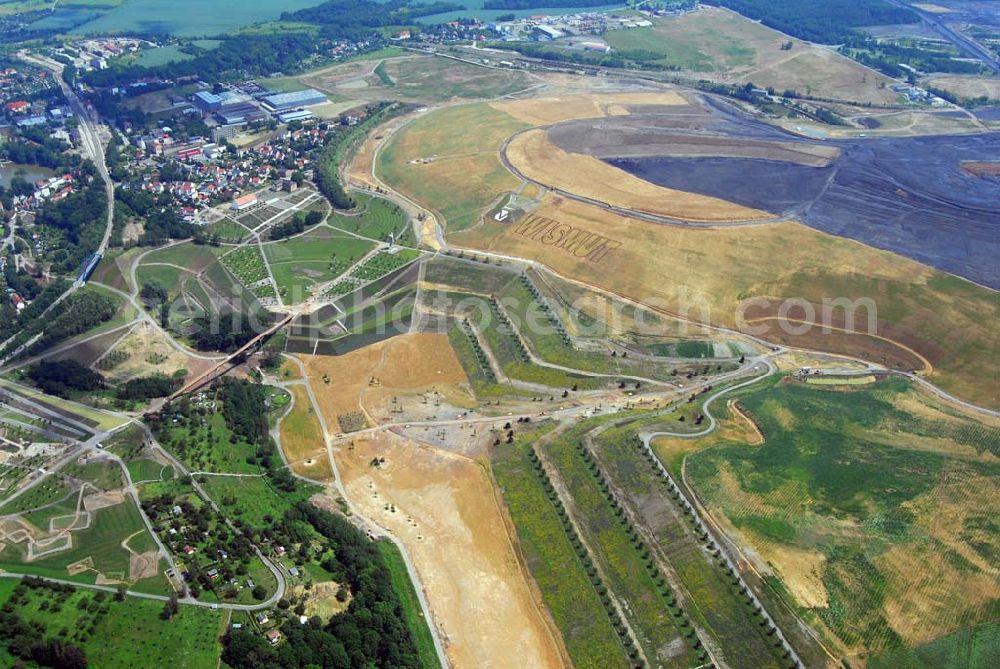 Aerial image Ronneburg - - Auf dem Ronneburger Gelände der Bundesgartenschau 2007 (Buga), einem ehemaligen Uranabbaugebiet der Wismut, gibt es keine gefährliche radioaktive Strahlung mehr. Das ist das Ergebnis einer Expertise des Öko-Instituts Darmstadt. Die Gartenschau soll vom 27. April 2007 an mindestens 1,5 Millionen Besucher nach Gera und Ronneburg locken. Die unabhängigen Ingenieure analysierten Messwerte, die in den vergangenen Jahren von der Wismut und an deren Institutionen erhoben wurden.