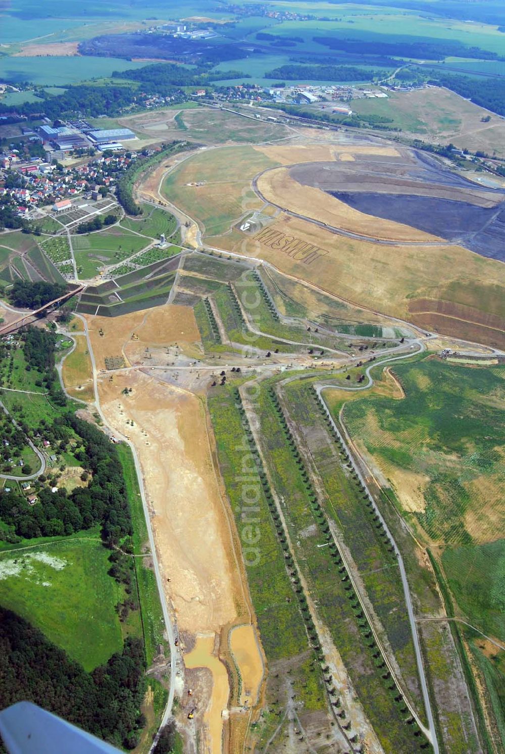 Aerial photograph Ronneburg - - Auf dem Ronneburger Gelände der Bundesgartenschau 2007 (Buga), einem ehemaligen Uranabbaugebiet der Wismut, gibt es keine gefährliche radioaktive Strahlung mehr. Das ist das Ergebnis einer Expertise des Öko-Instituts Darmstadt. Die Gartenschau soll vom 27. April 2007 an mindestens 1,5 Millionen Besucher nach Gera und Ronneburg locken. Die unabhängigen Ingenieure analysierten Messwerte, die in den vergangenen Jahren von der Wismut und an deren Institutionen erhoben wurden.