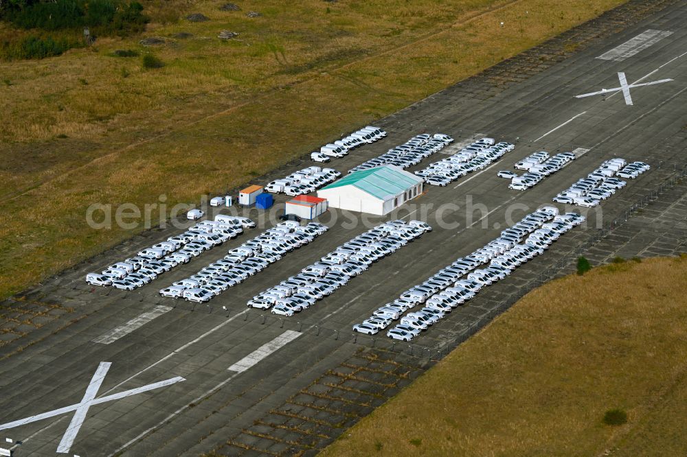 Aerial image Werneuchen - Automobiles - passenger cars on the parking areas in the open-air area of a vehicle reconditioner and converter on a closed area of the runway of the airfield in the district of Hirschfelde in Werneuchen in the federal state of Brandenburg, Germany